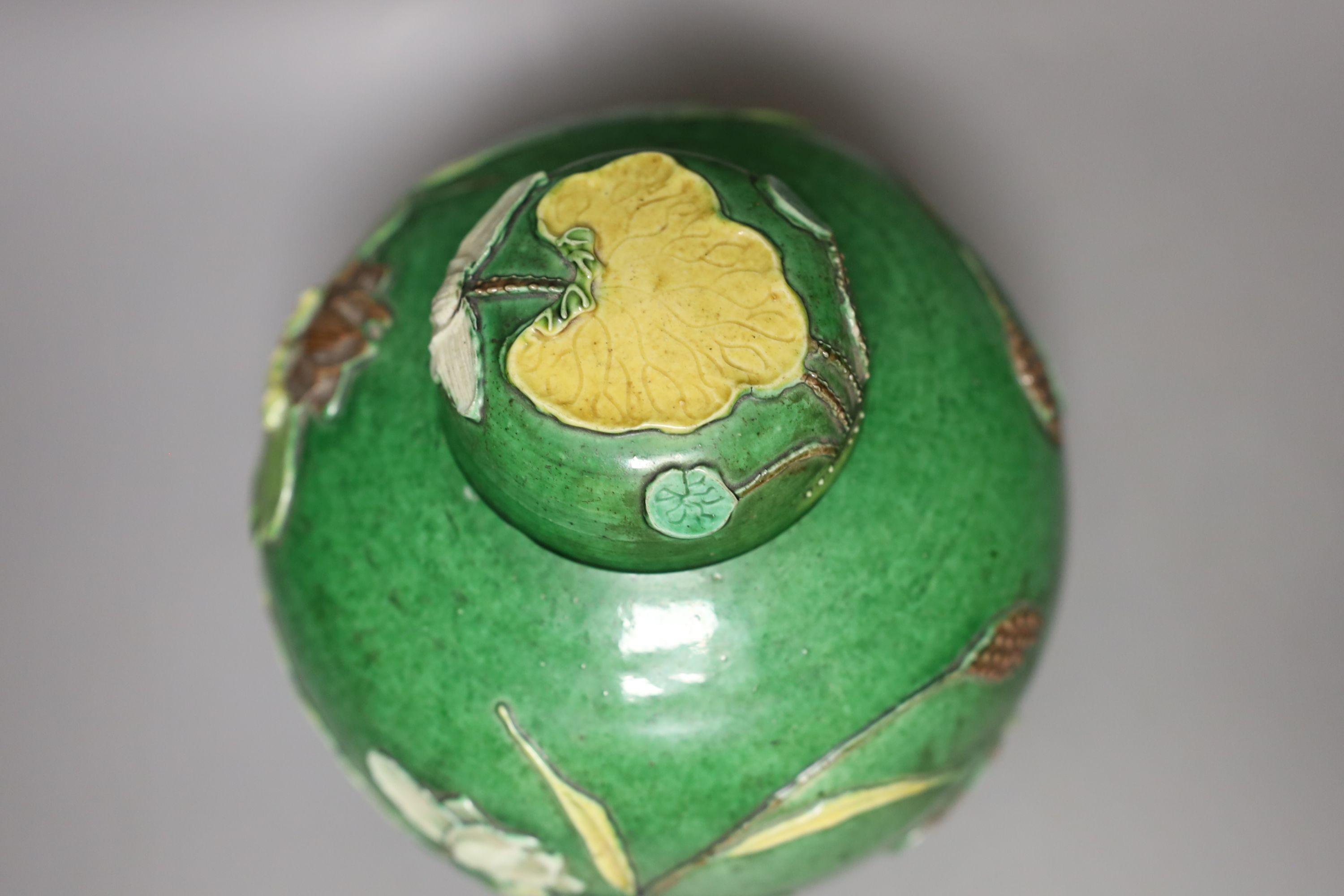 An early 20th century Chinese green-glazed ‘lotus’ jar and cover 18cm